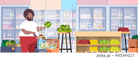 fat obese man with shopping trolley cart choosing vegetables and fruits overweight african american fat obese man with shopping trolley cart choosing vegetables and fruits overweight african american 49584027