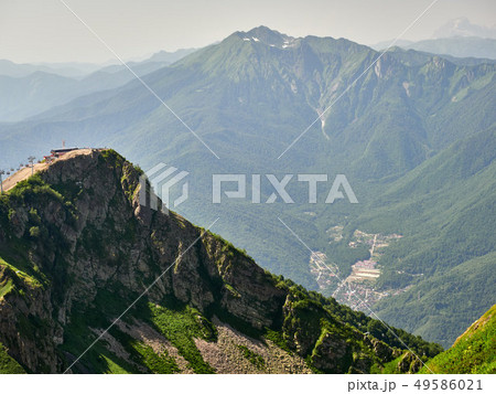 The peaks of a high mountain slope with cable car 49586021
