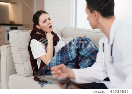 Doctor Visiting Sick Young Woman in Scarf at Home. Doctor Visiting Sick Young Woman in Scarf at Home. 49587635