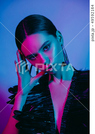 High Fashion model in colorful bright neon lights posing at studio 49592164