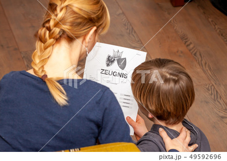Mother comforting son despite the bad school certificate - Translation: certificate day of birth Mother comforting son despite the bad school certificate - Translation: certificate day of birth 49592696