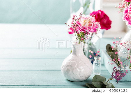 Bouquet of pink carnation on light turquoise wooden background 49593122