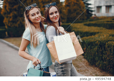 Cute girls with shopping bag in a city Cute girls with shopping bag in a city 49594748