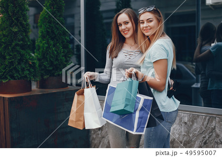 Cute girls with shopping bag in a city Cute girls with shopping bag in a city 49595007