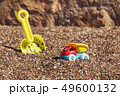 Children's toy truck with gravel or sand. Yellow scoop on the background. Concept of transportation 49600132