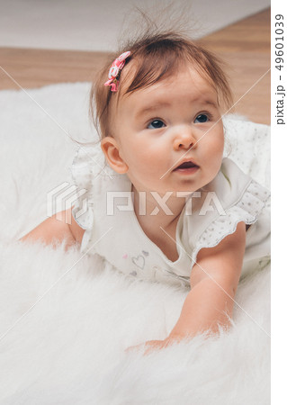 little girl with a tail on her head crawling on little girl with a tail on her head crawling on 49601039