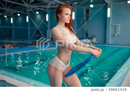 Beautiful young woman in the indoor swimming pool. Beautiful young woman in the indoor swimming pool. 49601420