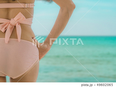 Back view of sexy adult Asian woman on the beach. Back view of sexy adult Asian woman on the beach. 49602065