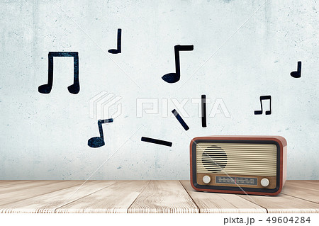 3d rendering of a retro radio receiver on a wooden surface and hand-drawn musical notes on the wall. 3d rendering of a retro radio receiver on a wooden surface and hand-drawn musical notes on the wall. 49604284