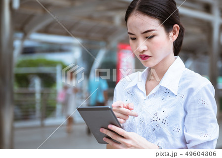An office woman serious looking on tablet An office woman serious looking on tablet 49604806