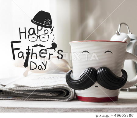 Cup with mustache on wooden table for fathers day 49605586