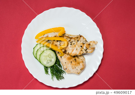 grilled chicken fillet on white plate 49609017