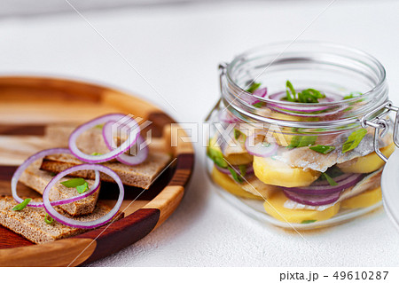 herring and potato appetizer with rye bread toasts 49610287