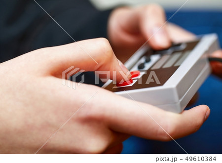 Playing an old gaming console 49610384