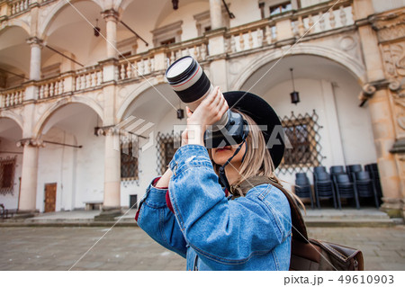 Young woman, professional photographer with camera in old castle. 49610903