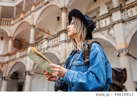Young woman, professional photographer with camera in old castle. 49610913