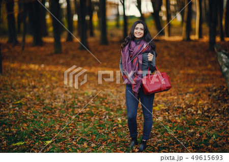 brunette girl relaxing at the park brunette girl relaxing at the park 49615693