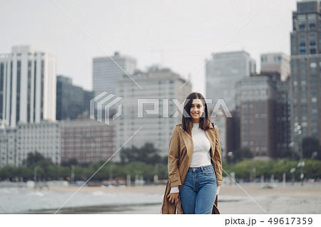 young girl walking on the beach young girl walking on the beach 49617359