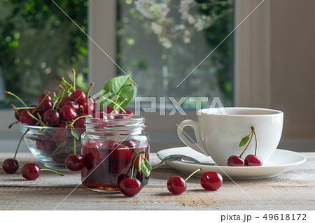 Tea and cherry jam on a wooden table 49618172