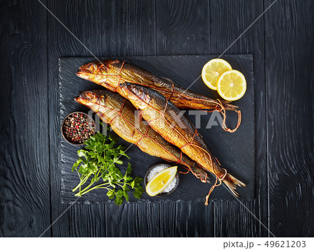 hot smoked herrings on a slate tray 49621203