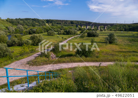 dirt road near the river bank leading to a beautif 49622051