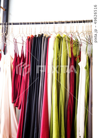 Fashionable clothes is hanging in the store Fashionable clothes is hanging in the store 49626516