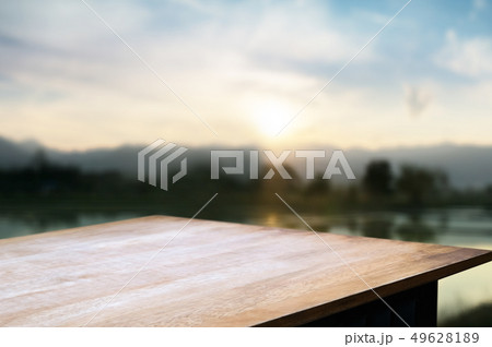 wood tabletop with blurred amazing landscape background. wood tabletop with blurred amazing landscape background. 49628189