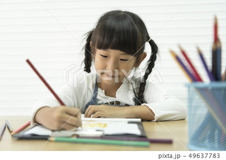 Asian child drawing paint on table in school 49637783
