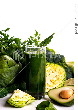 Smoothie drink with avocado, lime and spinach on white wooden background. Raw food and drink. Smoothie drink with avocado, lime and spinach on white wooden background. Raw food and drink. 49637877