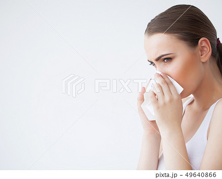 Woman Suffering From Cold In Home With Tissue 49640866