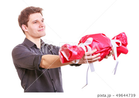 Man with big red candy. 49644739