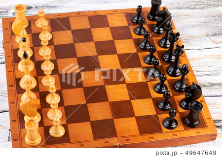 Wooden chess pieces placed on chess board. Wooden chess pieces placed on chess board. 49647649