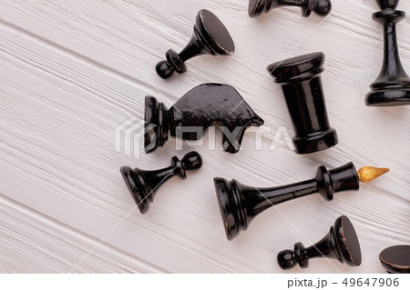 Black chess pieces on white wood. Black chess pieces on white wood. 49647906