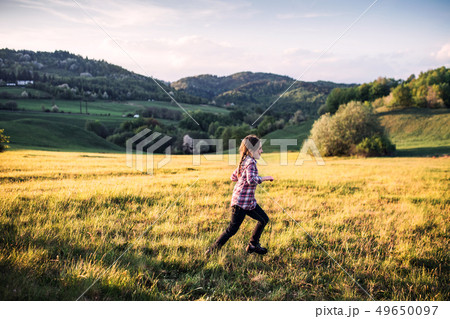 A small girl having fun outside in nature. 49650097