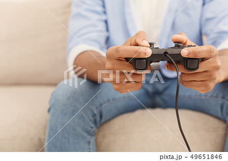 Young man playing video games at home Young man playing video games at home 49651846
