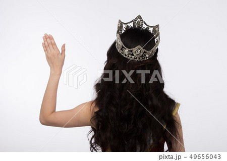 isolated of Miss Asian Pageant Beauty Contest in Red sequin Evening Ball Gown dress sparkle light Diamond Crown, Turn back Most Beautiful Woman wave hand to camera, studio lighting white background 49656043