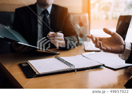 Men employee are describing the employment history 49657022