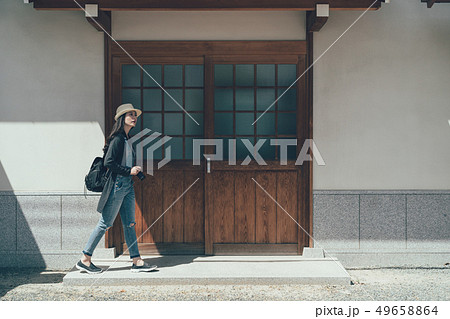 slender girl with backpack walk along old town slender girl with backpack walk along old town 49658864