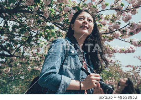 Photographer woman in colorful spring park 49658952