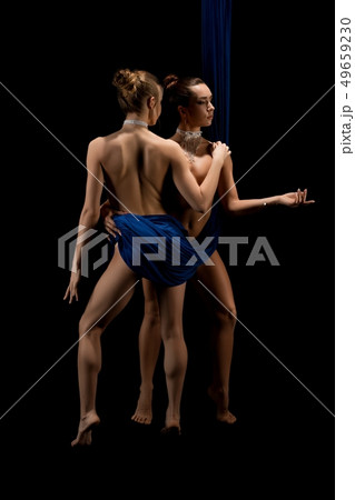 Naked females in blue cloth embracing each other Naked females in blue cloth embracing each other 49659230