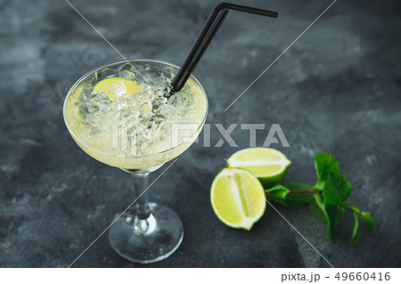 Mojito cocktail in glass and lime fruit on a table Mojito cocktail in glass and lime fruit on a table 49660416