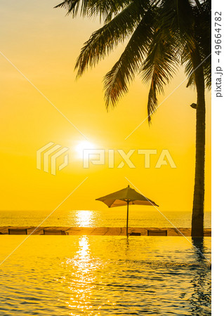 Beautiful landscape outdoor swimming pool with umbrella and deck chair in hotel resort for relax travel and vacation 49664782