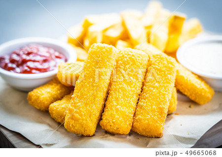 Fish finger and french fries or chips with tomato ketchup and mayonnaise sauce Fish finger and french fries or chips with tomato ketchup and mayonnaise sauce 49665068
