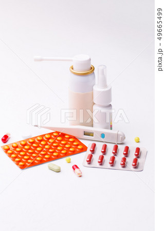 Treatment of flu. Throat spray, nose drops, cold pills and thermometer on white background. Treatment of flu. Throat spray, nose drops, cold pills and thermometer on white background. 49665499