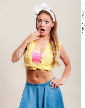 Amazed surprised pin up girl with mouth wide open. 49665997