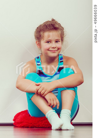 Happy joyful little girl kid sitting on pillow. 49666039