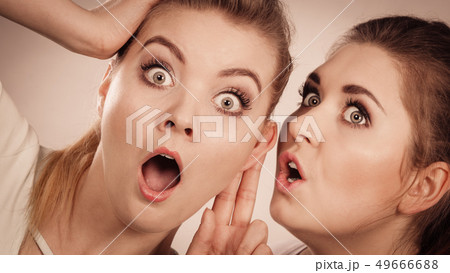 Two women telling gossip 49666688
