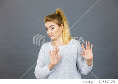 Woman deny something showing stop gesture with 49667375