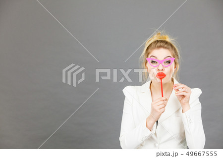 Happy elegant woman holding carnival accessoies on 49667555