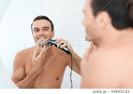 Mirror Reflection of Man Brush Teeth in Bathroom Mirror Reflection of Man Brush Teeth in Bathroom 49669185